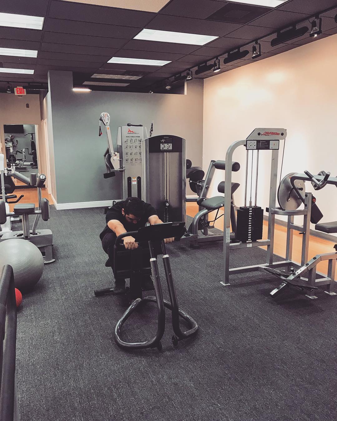 Patient training on a leg press in the Instinct Health Care rehabilitation gym